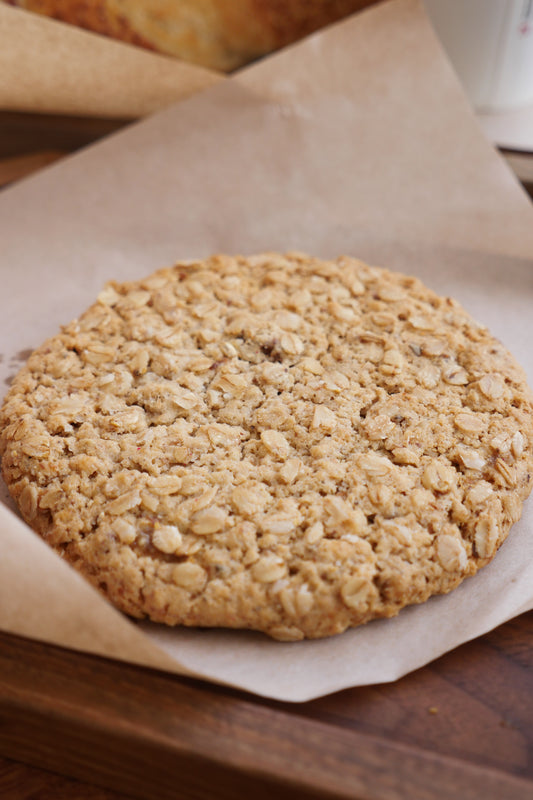 Designer placeholder: premium product photography for The Indulgence Box styled on cream linen with warm bakery lighting.